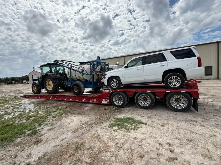 Lowboy trailer hauling construction machinery